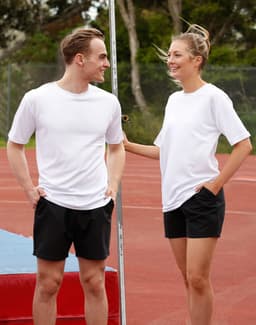 A white unisex short sleeve tee is displayed on a male and female model, set against an outdoor sports background.