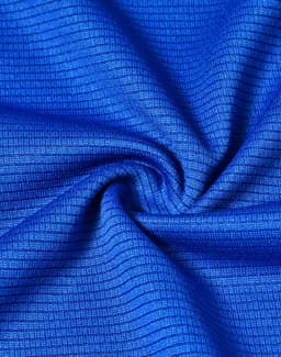 A close-up of blue textured fabric, showcasing a lightweight and performance-oriented material.