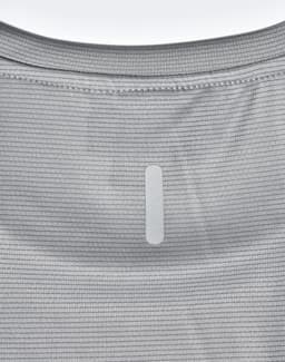 A light grey performance t-shirt featuring a textured pattern and a logo patch on the back.