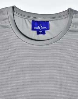 A grey short sleeve performance t-shirt featuring a round neckline and a label at the neck with branding.
