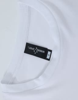 A white long-sleeve tee with a round neckline, featuring a label and a logo.