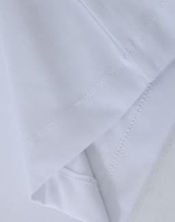 A close-up of a white premium cotton long-sleeve T-shirt showcasing its fabric texture and stitching details.
