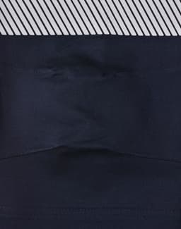 A pair of navy blue unisex cotton stretch ripstop segmented work pants with a patterned waistband and a logo.