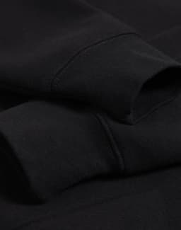 A black 1/2 zip collar fleecy jumper with visible sleeve cuffs and a subtle logo.