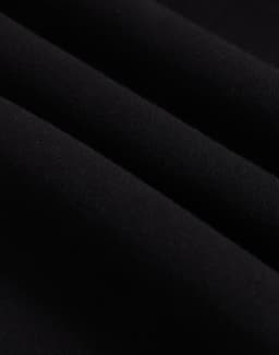A close-up of black polar fleece fabric, showcasing its soft texture and layering. The image features a logo.