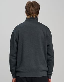 A grey 1/2 zip collar fleecy jumper with a relaxed fit, featuring a branded logo on the back.