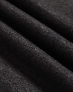 A close-up of dark grey polar fleece fabric with a soft, textured surface.