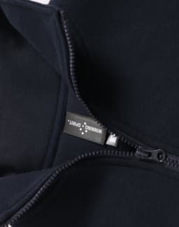 A navy blue polar fleece jumper featuring a half zip collar and a woven label inside.