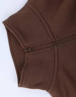 A brown 1/2 zip collar polar fleece jumper featuring a zip on the neckline. It has a smooth texture and a logo.