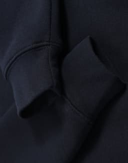 A navy blue fleece sweat with a half zip collar and cuffed sleeves, featuring a logo on the fabric.