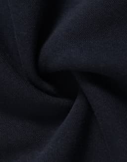 A close-up of navy fleece fabric showcasing its soft texture and smooth finish. The fabric has a subtle sheen.