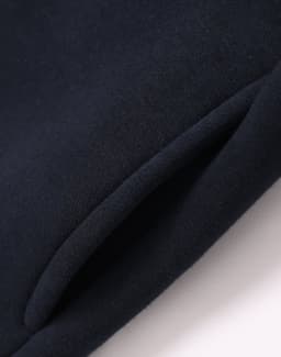 A navy fleecy sweatshirt featuring a half zip collar and a smooth fabric finish. It has a branded logo.