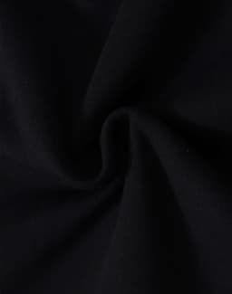 A close-up of black fleecy fabric, showcasing the soft texture and swirl pattern.