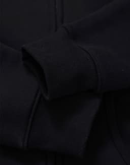 A black full-zip fleecy hoodie with a smooth fabric texture and a close-up view of the sleeve.