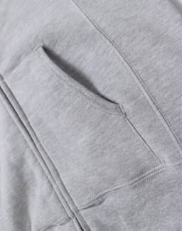 A grey ladies' full-zip fleecy hoodie featuring a front pocket and soft fabric texture. The hoodie has a branding logo.