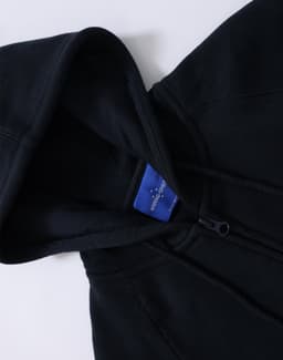 A ladies' full-zip fleecy hoodie in black, featuring a hood and a logo on the interior label.