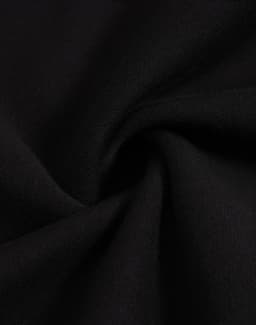 A close-up view of black fleece fabric, showcasing its soft texture and smooth finish.