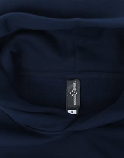 A navy oversized hoodie featuring a fleece interior and a label inside the collar.