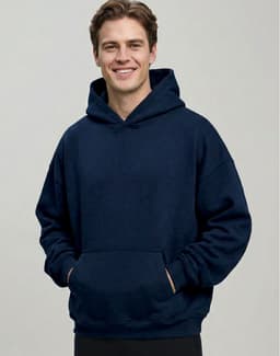 A man wearing a navy unisex premium fleece oversized hoodie with a front pocket and a hood.