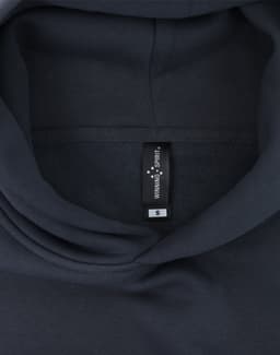 A dark grey oversized hoodie featuring an internal label and a hood design. Contains a branding logo.