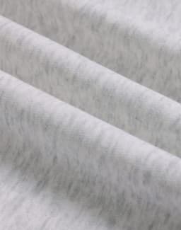 A close-up of soft, grey fabric showing a textured, fleece surface with subtle variations.