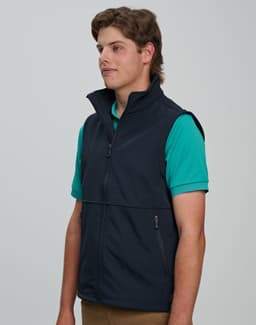 A men's softshell vest in navy blue, featuring a zip front and side pockets, worn over a green shirt.