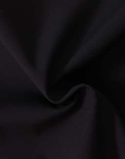 A close-up of black fabric featuring a soft texture, ideal for softshell jackets.