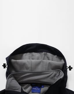 A black softshell full zip hoodie with a grey interior lining and adjustable toggles on the hood.