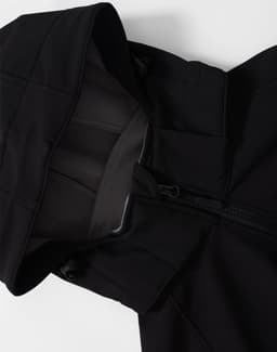 A black men's softshell full zip hoodie featuring a hood and zipped front. It has a logo on the fabric.