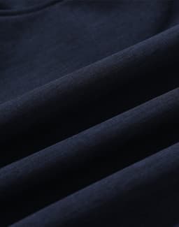 A navy blue softshell fabric displaying smooth, folded sections, featuring a logo. Suitable for a full zip hoodie.