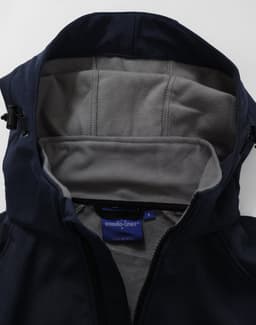 A navy softshell full zip hoodie with a grey fleece-lined interior and hood. Features a small logo inside.