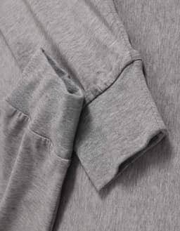 A grey long-sleeve tee shirt with a soft fabric and cuffed sleeves, featuring a logo on the side.