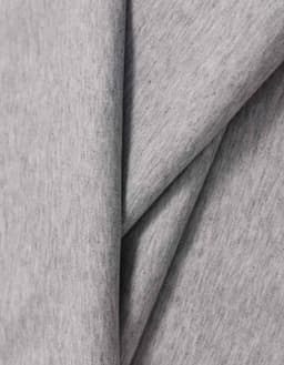 A grey cotton fabric with a soft, textured finish, draping smoothly in folds.