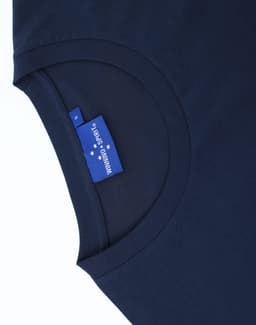 A navy blue men's long sleeve cotton tee shirt featuring a round neckline and a tag inside the collar.