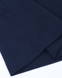 A navy blue long-sleeve tee shirt made of premium cotton, featuring stitched hems and a logo.
