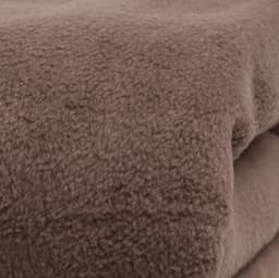 A close-up of a soft, brown thermal blanket with a textured surface, showcasing its warm and cosy material.