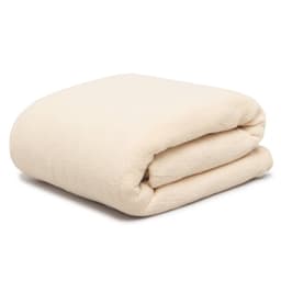 A folded thermal blanket in a soft cream colour, featuring a plush texture. The blanket has a simple design and includes a logo.
