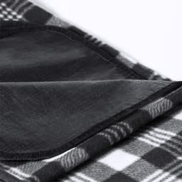 A black and grey checkered blanket with a smooth black backing, featuring a stitched edge. It has a logo on the corner.