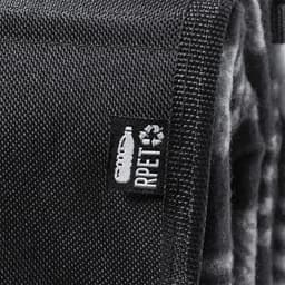 A black picnic rug with a textured surface and a tag featuring a logo. The blanket has a soft, plush interior.