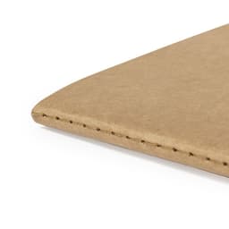 A notebook with a tan, textured cover, featuring visible stitching along the edge. It has a minimalistic design.