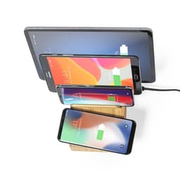 A wireless charger in a wooden stand, featuring multiple devices in varying sizes above it, including smartphones and a tablet.