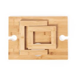 A bamboo serving table featuring three nested frames in varying sizes. The table has a round cutout for easy handling.