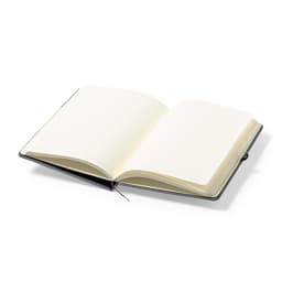 A black notebook with blank cream pages, open to reveal its interior, featuring a ribbon bookmark.