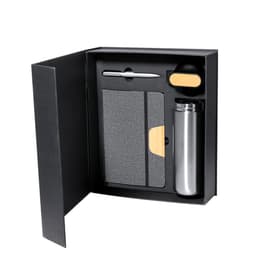 A gift set featuring a grey notebook, silver drink bottle, silver pen, and a black item with a wooden accent, all in a black box.