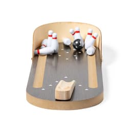 A tabletop bowling game featuring a wooden ramp, nine white pins with red stripes, and a black bowling ball.