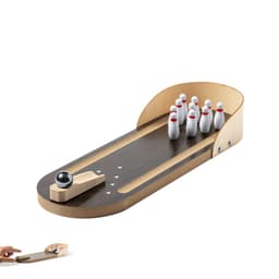 A miniature bowling game featuring a wooden lane, pins in white with red bands, and a black bowling ball.