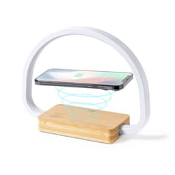 A wireless charger lamp featuring a curved white design and a bamboo base, with a smartphone positioned above.