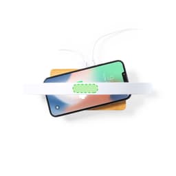 A wireless charger lamp in white, positioned above a smartphone on a wooden surface, with charging cables visible.