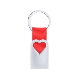 A silver keyring with a heart-shaped cutout on a red fabric strap. It features a simple, modern design.
