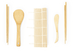 A bamboo sushi making set including chopsticks, a spatula, a rolling mat, and a shaping tool.